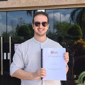 Dr Abderrahim Zermane holding his doctoral thesis